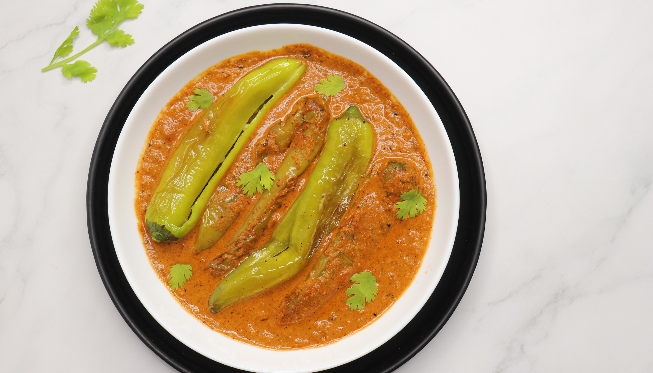 A traditional Hyderabadi spicy and tangy gravy made with peanuts, sesame seeds, and green chilies, typically served as an accompaniment to biryani.