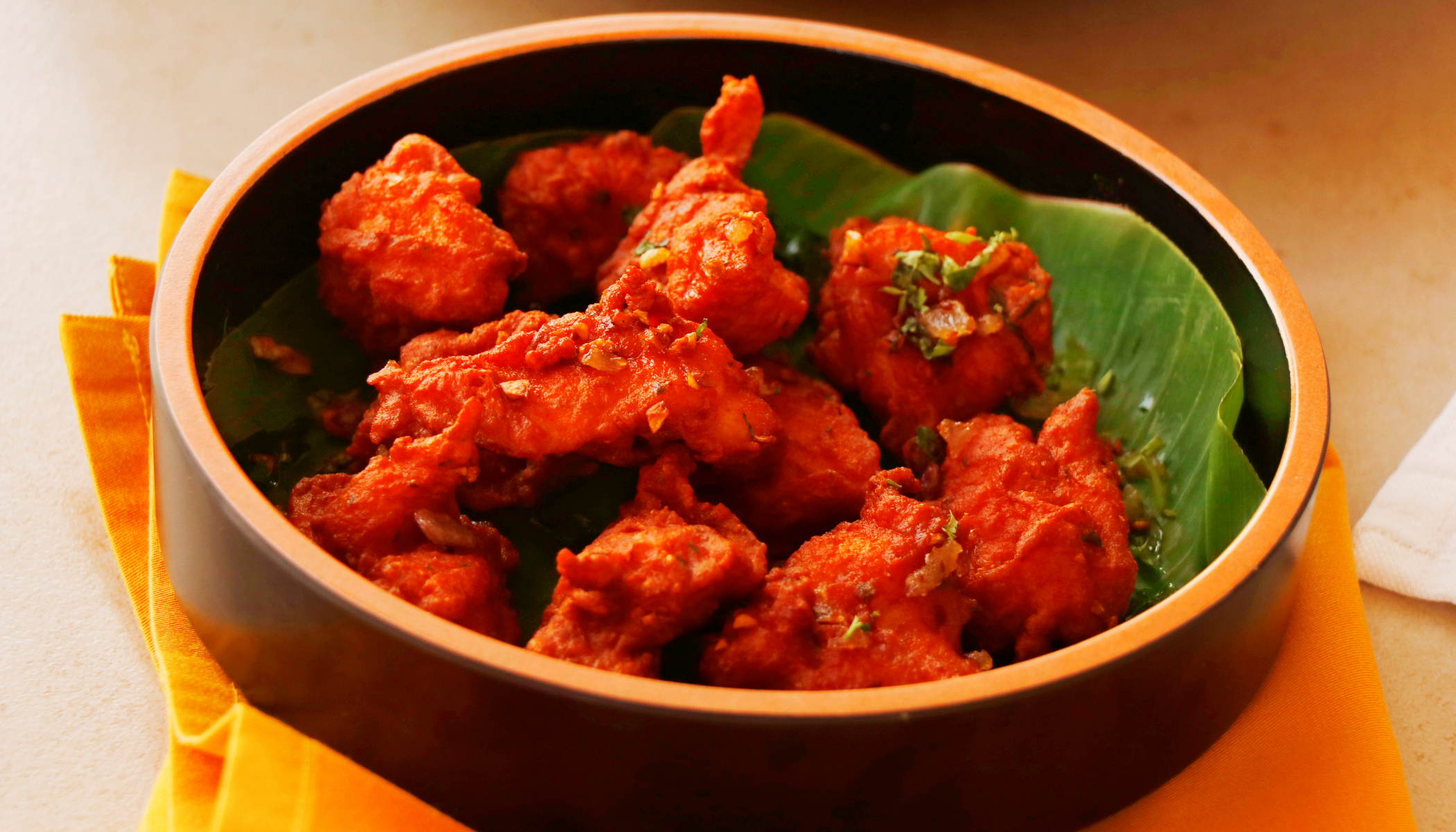 Fiery and flavorful South Indian-style chicken bites, deep-fried and tossed with garlic, curry leaves, and a touch of tang. NO COLORS NO ADDITIVES.